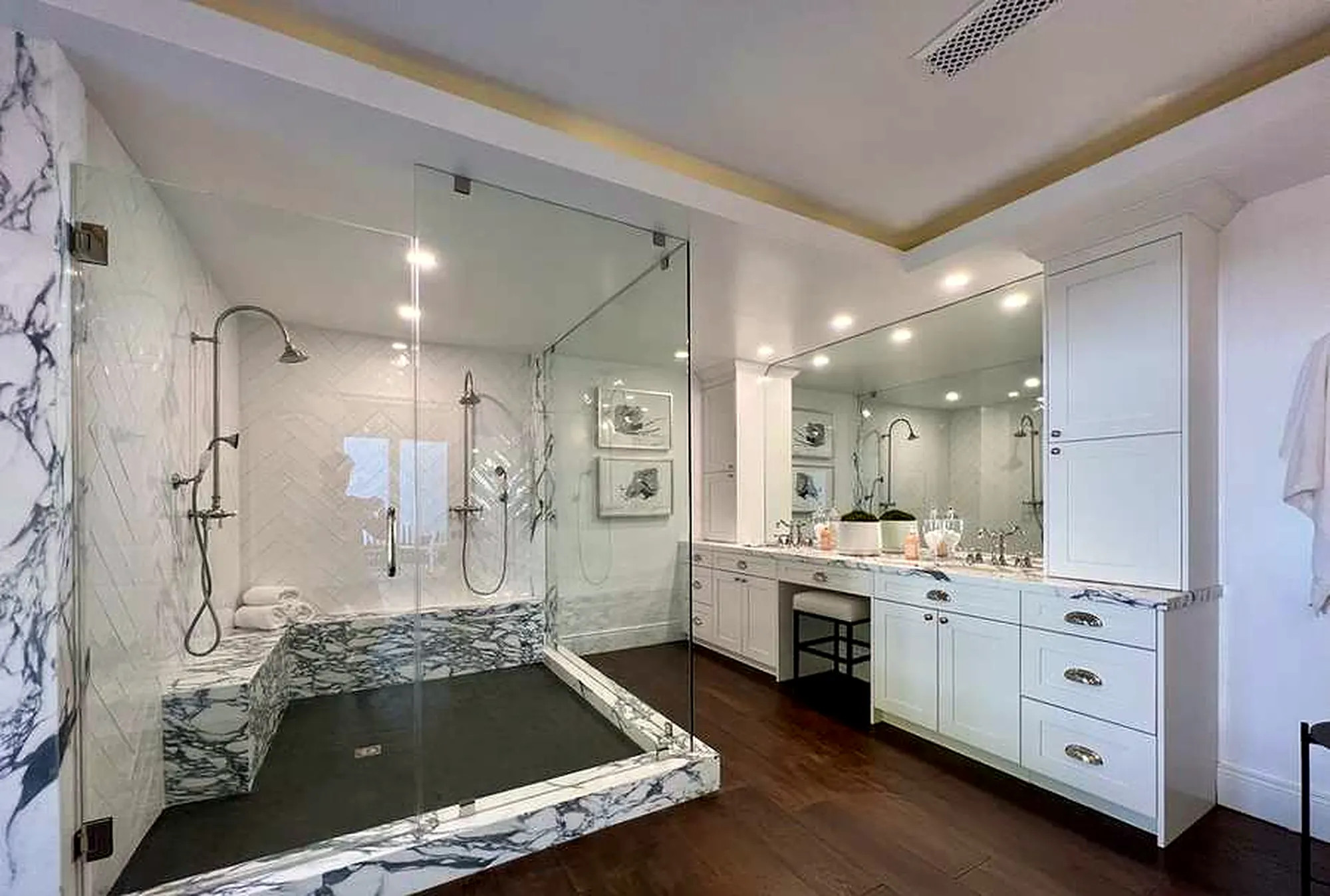 Marble primary bathroom with glass shower in Encino